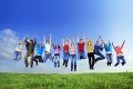 Big group of young jumping people with hands up.